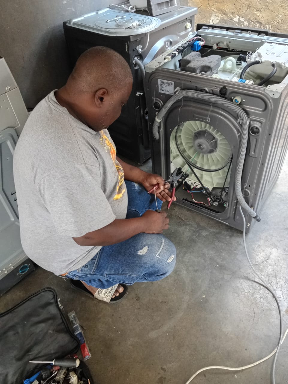 Technician repairing a washing machine